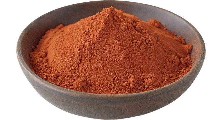 A bowl of bright red tomato powder placed on a solid white background., viewed from the side